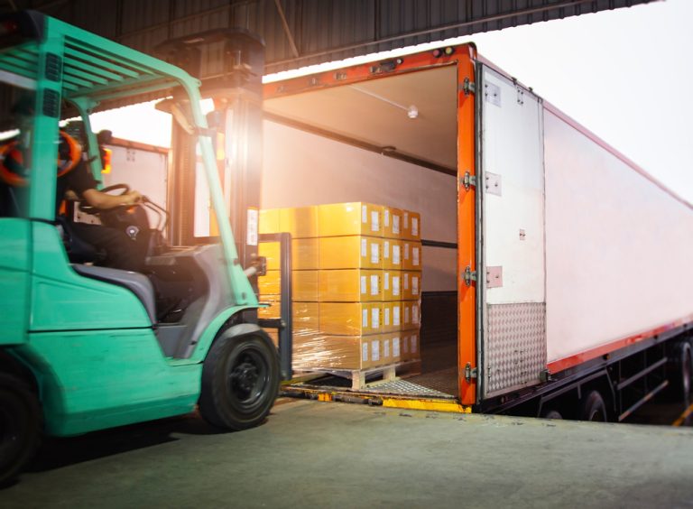 green forklift unloading lorry