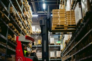 electric reach truck operator in warehouse